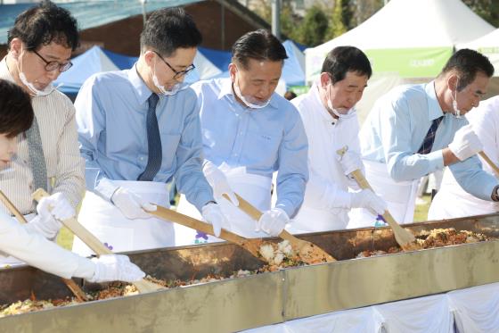 김영환(가운데) 충북지사와 이재영(오른쪽 두번째) 증평군수가 12일 열린 증평인삼골축제장에서 비빔밥을 만들고있다.