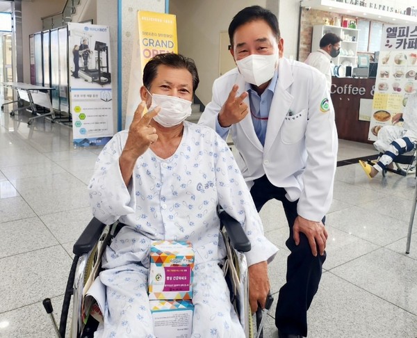 환자의 휠체어를 밀어주며 '공감'으로 다가서는 임수흠원장.