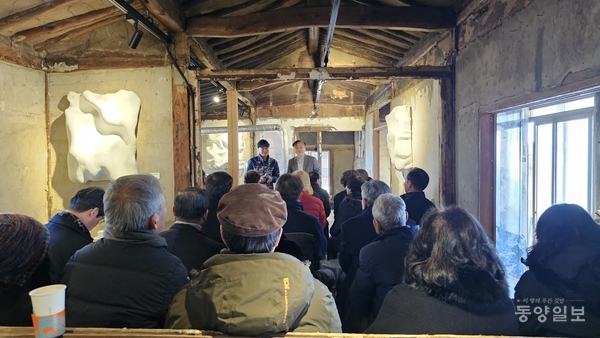 골조가 드러난 김복진 생가 본채에서 마을주민들과 관계자들이 함께하고 있다.